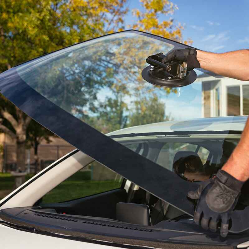 A man installs a car window, highlighting Excellence Auto Glass's trusted repair service in Burnaby.